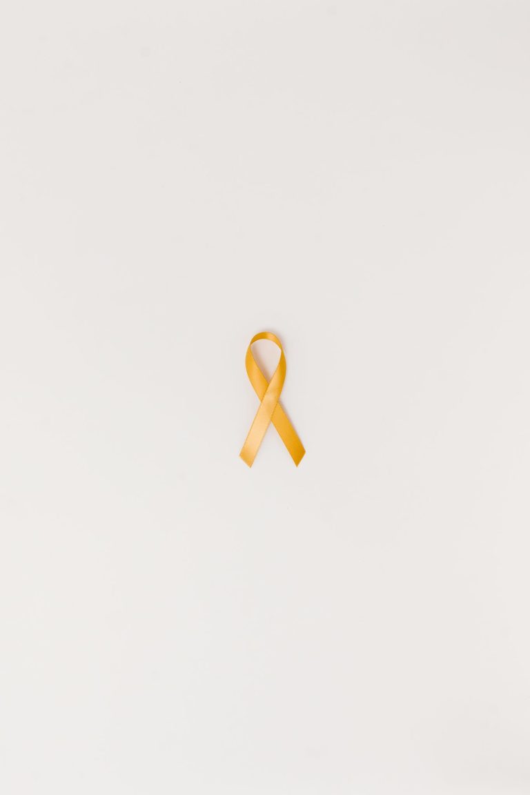 A Yellow Ribbon on a White Surface