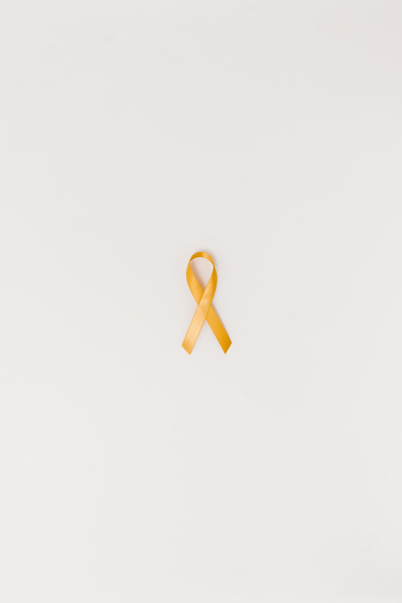 A Yellow Ribbon on a White Surface